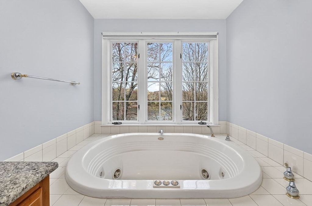 792 A Jerusalem Road Cohasset, MA 02025 - Photo 27 of 42 a white bath tub sitting in a bathroom next to a window