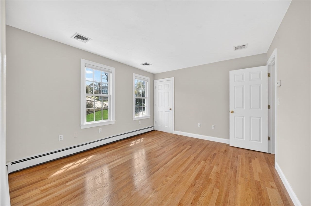 792 A Jerusalem Road Cohasset, MA 02025 - Photo 30 of 42 a view of an empty room with wooden floor and a window