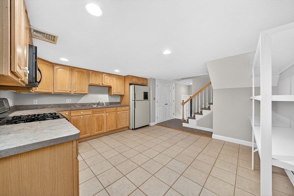 792 A Jerusalem Road Cohasset, MA 02025 - Photo 32 of 42 a kitchen with stainless steel appliances granite countertop a refrigerator sink and cabinets