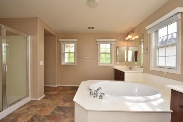 a bath tub sitting in a bathroom next to a window