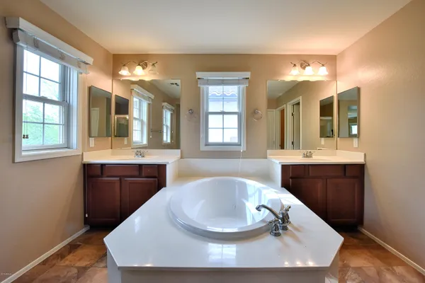 a large white kitchen with a sink and dish washer