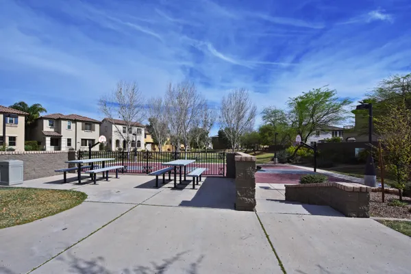 a view of a patio with couches and table and chairs with wooden fence