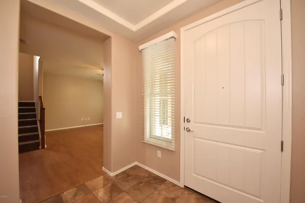 a view of hallway with stairs and wooden floor