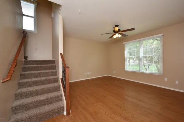a view of entryway and hall with a ceiling fan