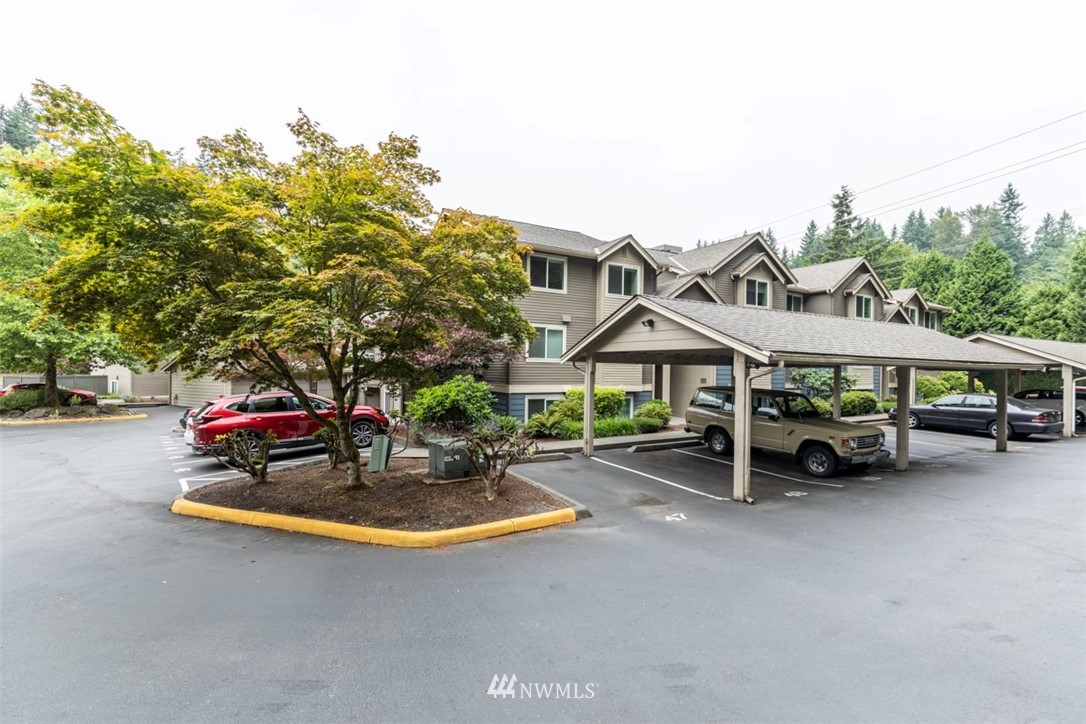 19410 Bothell Way Northeast, Unit D301 Bothell, WA 98011 - Photo 1 of 18 a view of a parked cars in front of a house