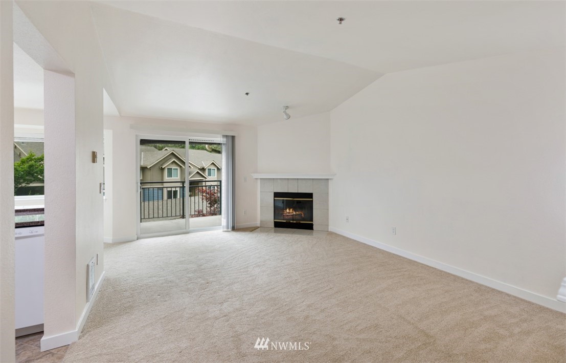 19410 Bothell Way Northeast, Unit D301 Bothell, WA 98011 - Photo 3 of 18 an empty room with windows and fireplace