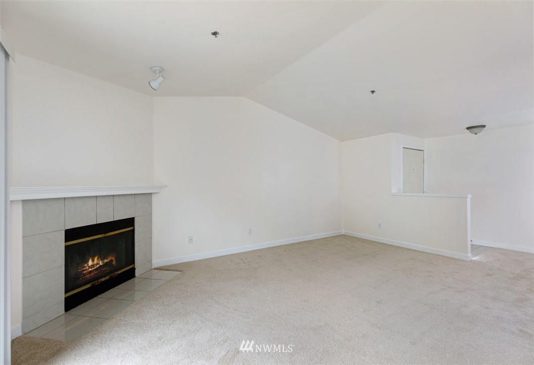 19410 Bothell Way Northeast, Unit D301 Bothell, WA 98011 - Photo 4 of 18 a view of an empty room with a fireplace