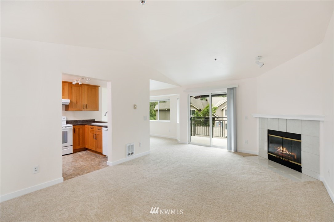 19410 Bothell Way Northeast, Unit D301 Bothell, WA 98011 - Photo 5 of 18 an empty room with windows and fireplace