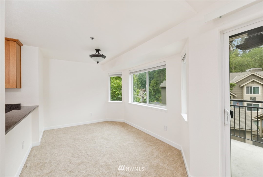 19410 Bothell Way Northeast, Unit D301 Bothell, WA 98011 - Photo 8 of 18 a view of a livingroom with a ceiling fan and window