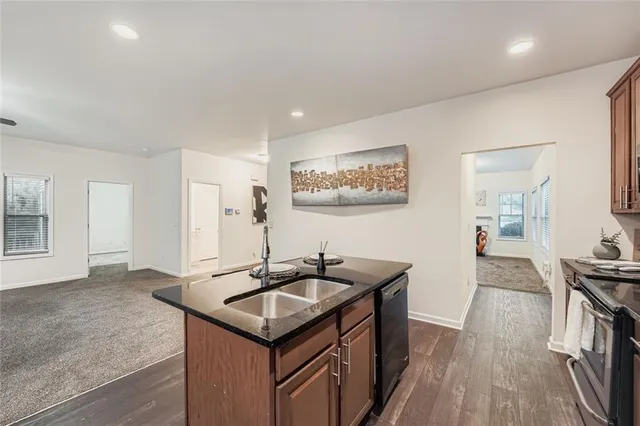 a kitchen with kitchen island a sink table and chairs