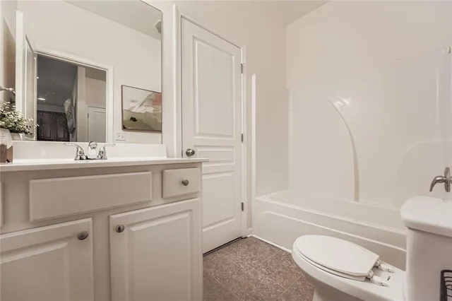 a view of a hallway and a livingroom with a chair