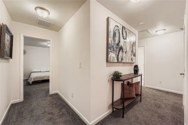 a spacious bedroom with a bed and a chandelier