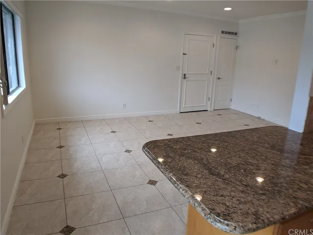 a kitchen with stainless steel appliances granite countertop a sink and a refrigerator