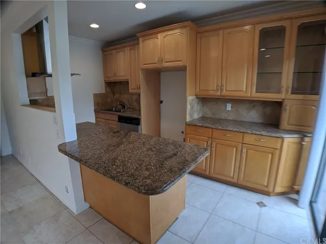 a kitchen with granite countertop a sink and a stove