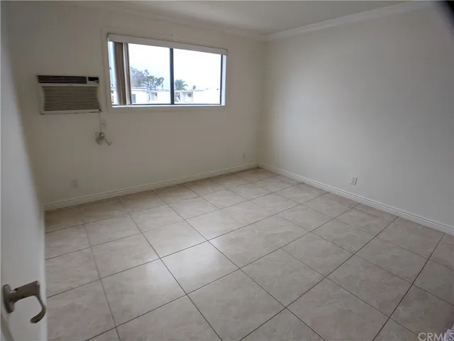 an empty room with white cabinet
