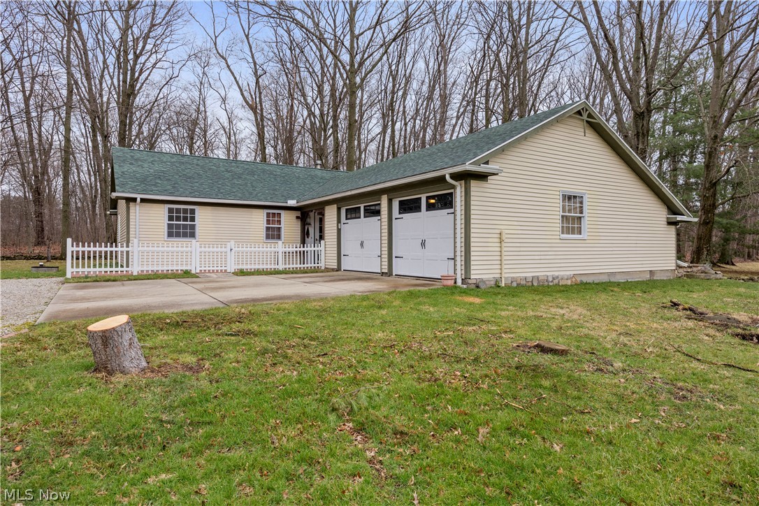 11923 Green Road Wakeman, OH 44889 - Photo 2 of 45 View of front of home with a shingled roof, concrete driveway, and an attached garage