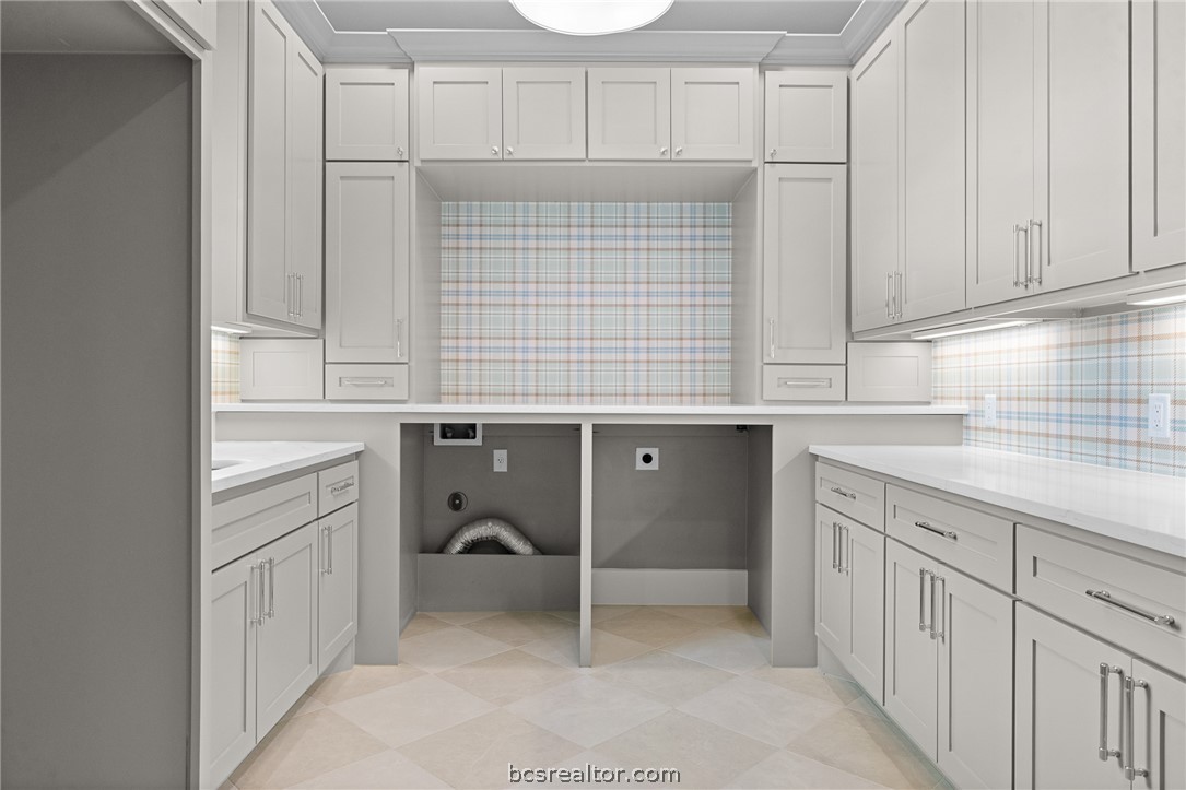 424 Pleasant Hill School Road Brenham, TX 77833 - Photo 20 of 26 Doing laundry should never be boring! This light and bright Laundry Room is spacious and highlighted with a classic plaid wallpaper.