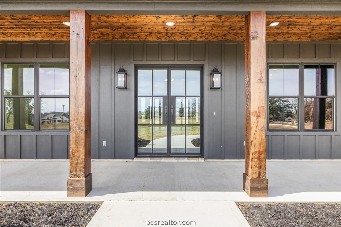 424 Pleasant Hill School Road Brenham, TX 77833 - Photo 23 of 26 The Front Entrance has great wood accents, and the iron doors serve as an attractive focal point.