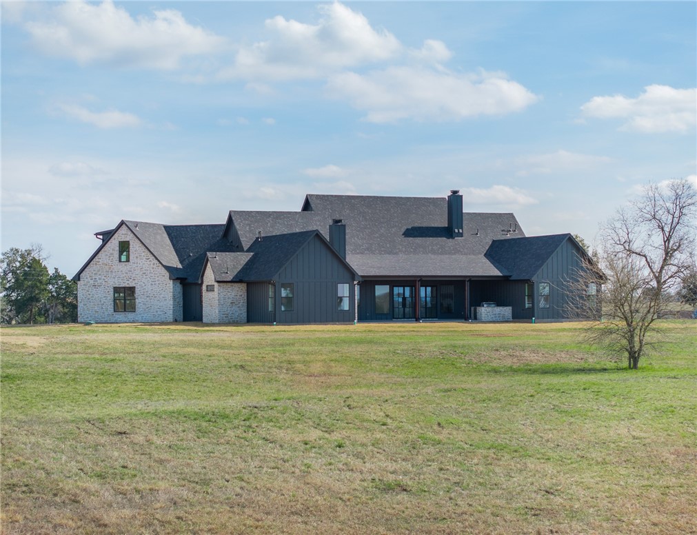 424 Pleasant Hill School Road Brenham, TX 77833 - Photo 24 of 26 The back of the home is just as appealing as every other inch of it! Sit on the large back porch, enjoy the fireplace and outdoor kitchen, and take in the views.