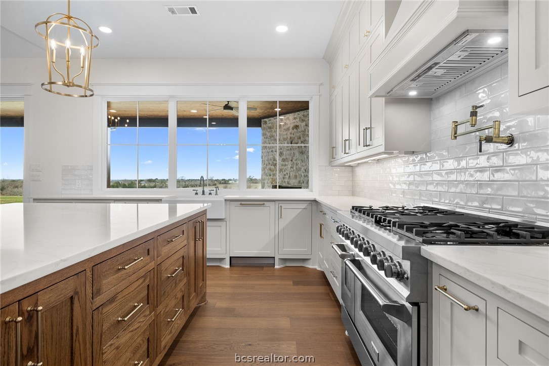 424 Pleasant Hill School Road Brenham, TX 77833 - Photo 5 of 26 Natural lighting that honors the incredible view are features of the kitchen.