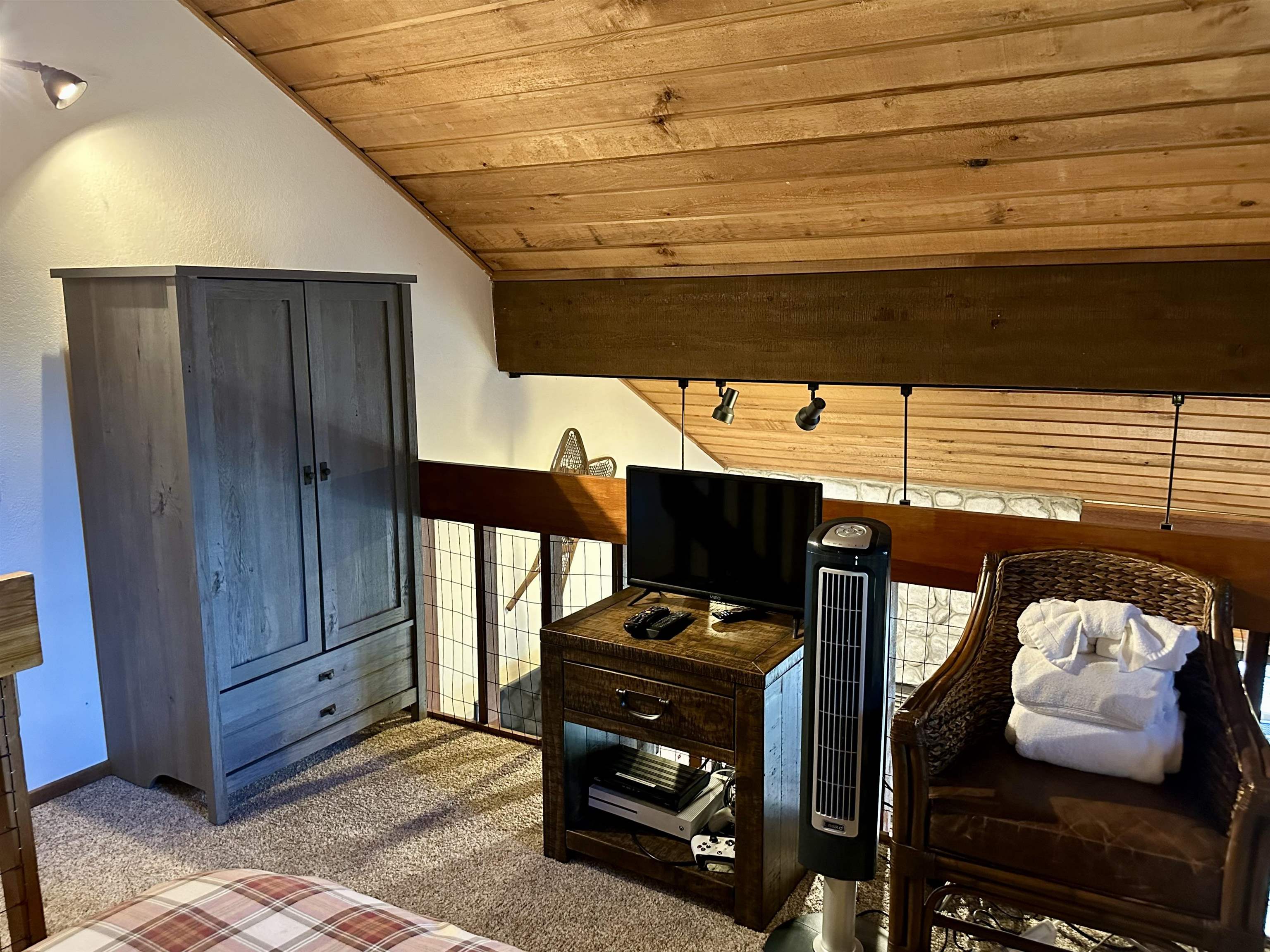 315 Fascination, Unit 315 Mammoth Lakes, CA 93546 - Photo 34 of 44 Angled white walls with recessed lighting, exposed wood-paneled ceiling, and a prominent dark wood beam with track lighting