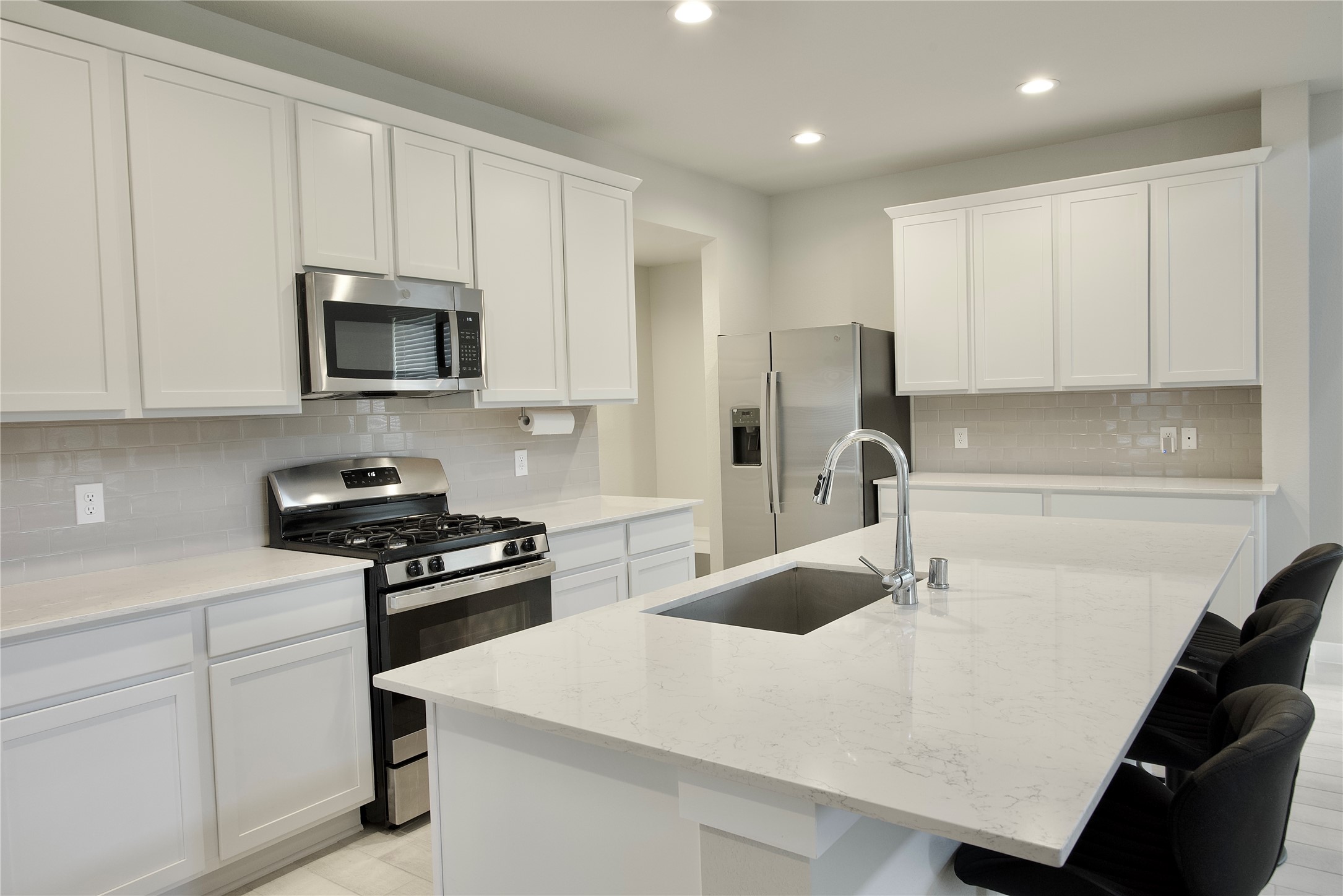 3207 Tilley Drive Rosenberg, TX 77471 - Photo 9 of 43 a kitchen with kitchen island a sink appliances and cabinets