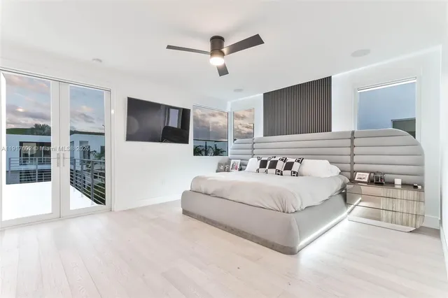 a large white bed in a white room