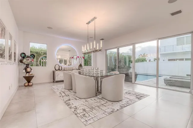 a view of a house with a large window couches and dinning table chair