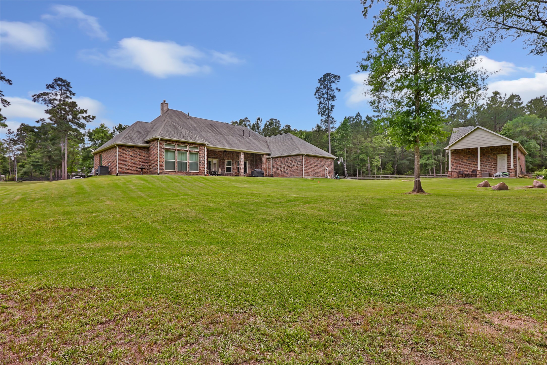 229 Sundog Road Huntsville, TX 77340 - Photo 50 of 50 Side view from the back yard. This property offers lots of space, cleared and wooded. Imagine a pool in this back yard! Make this home yours today!