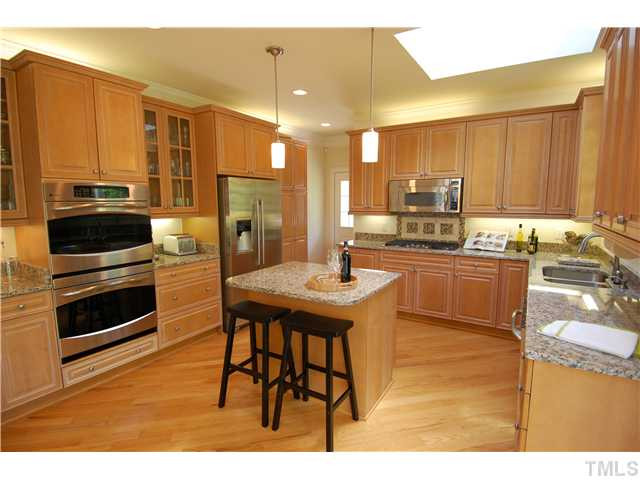 The kitchen is a chef's dream! With tons of custom cabinetry and GRANITE counters, gas cooktop, double oven, center island....what more could a chef ask for? Kitchen