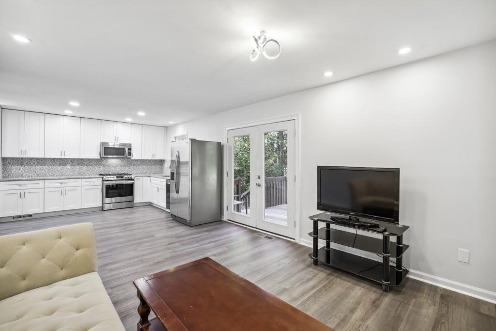 10145 Rillridge Court Alpharetta, GA 30022 - Photo 11 of 26 a living room with furniture and a flat screen tv