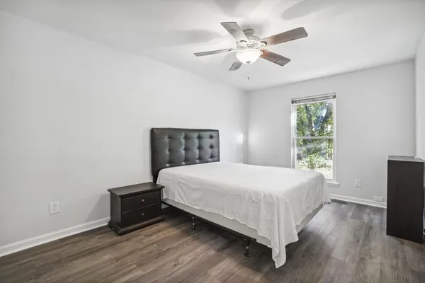 a bedroom with a bed and a window
