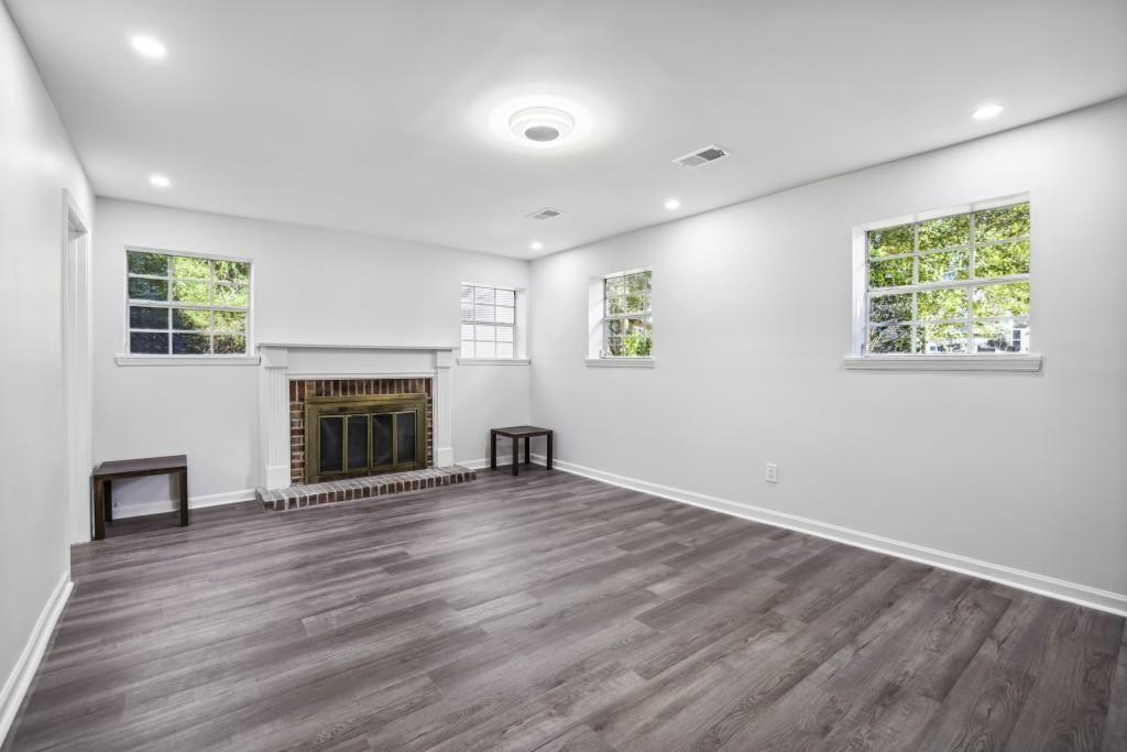 10145 Rillridge Court Alpharetta, GA 30022 - Photo 17 of 26 an empty room with windows and a fireplace