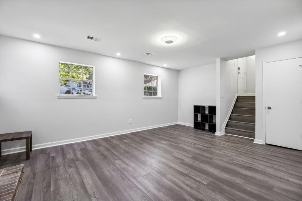 10145 Rillridge Court Alpharetta, GA 30022 - Photo 20 of 26 wooden floor in an empty room with a window