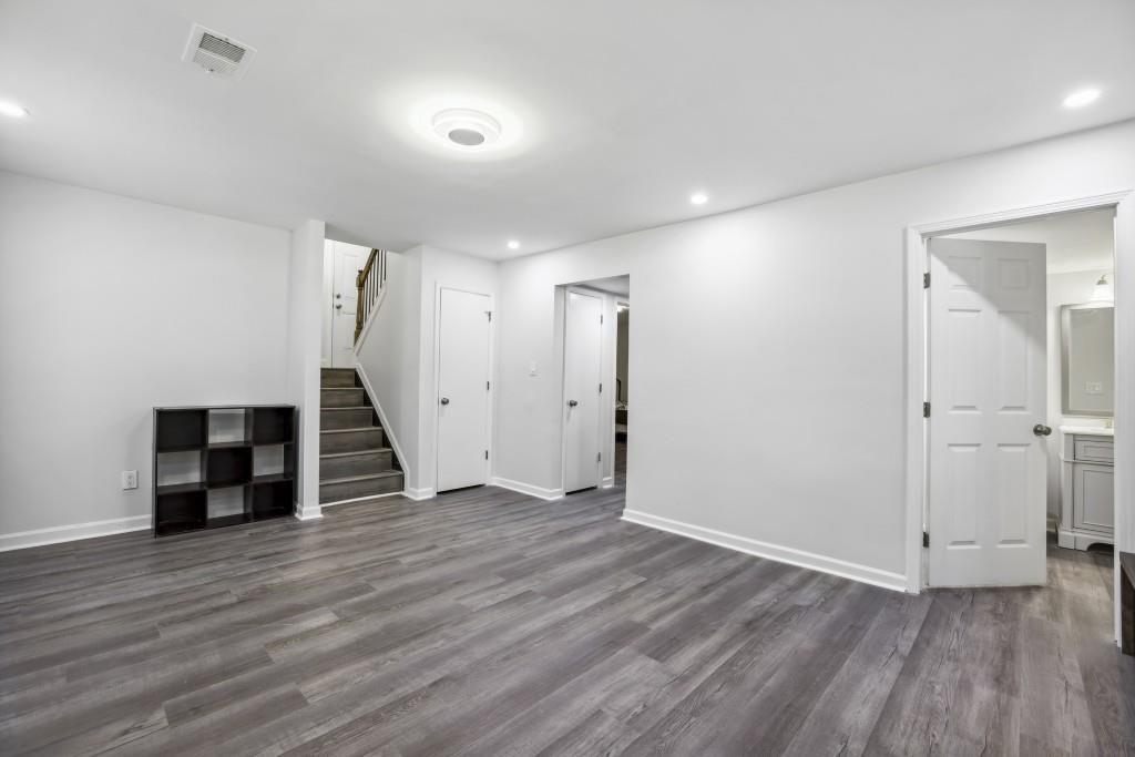 10145 Rillridge Court Alpharetta, GA 30022 - Photo 21 of 26 an empty room with wooden floor and windows