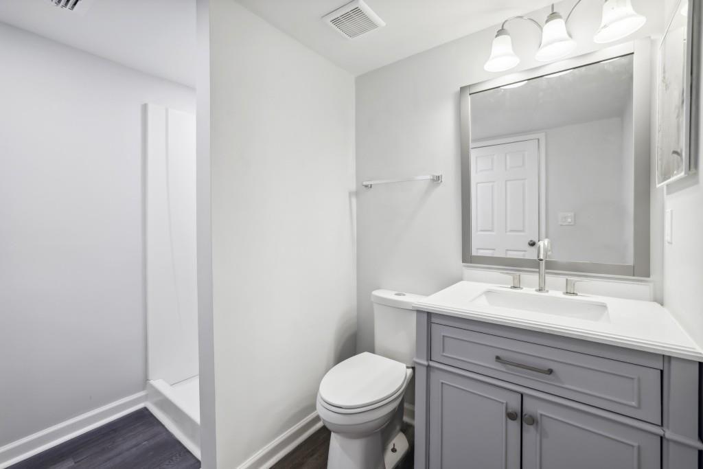 10145 Rillridge Court Alpharetta, GA 30022 - Photo 22 of 26 a bathroom with a toilet sink and mirror