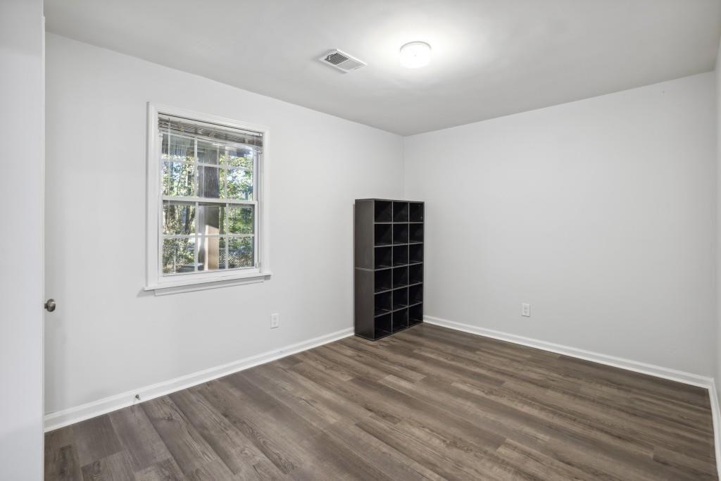 10145 Rillridge Court Alpharetta, GA 30022 - Photo 24 of 26 an empty room with wooden floor and windows