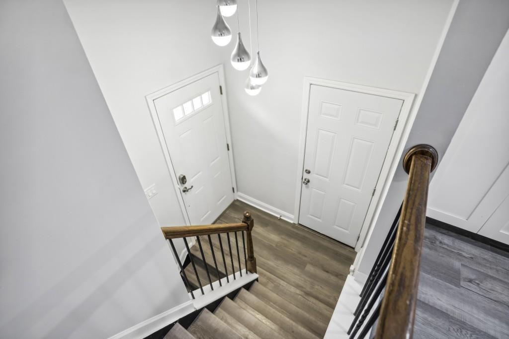 10145 Rillridge Court Alpharetta, GA 30022 - Photo 3 of 26 a view of a hallway with wooden floor and staircase