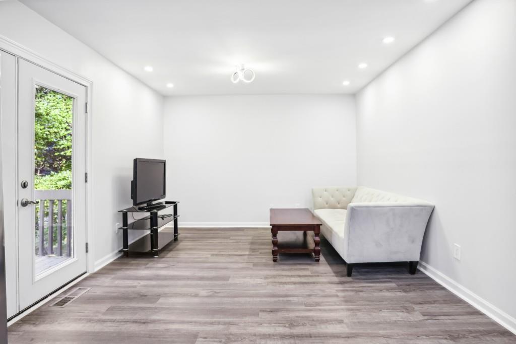 10145 Rillridge Court Alpharetta, GA 30022 - Photo 7 of 26 a living room with furniture and a flat screen tv