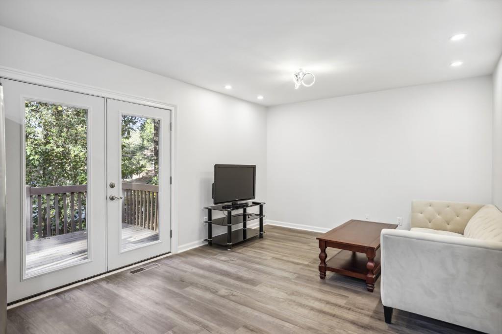 10145 Rillridge Court Alpharetta, GA 30022 - Photo 8 of 26 a view of livingroom with furniture and a flat screen tv