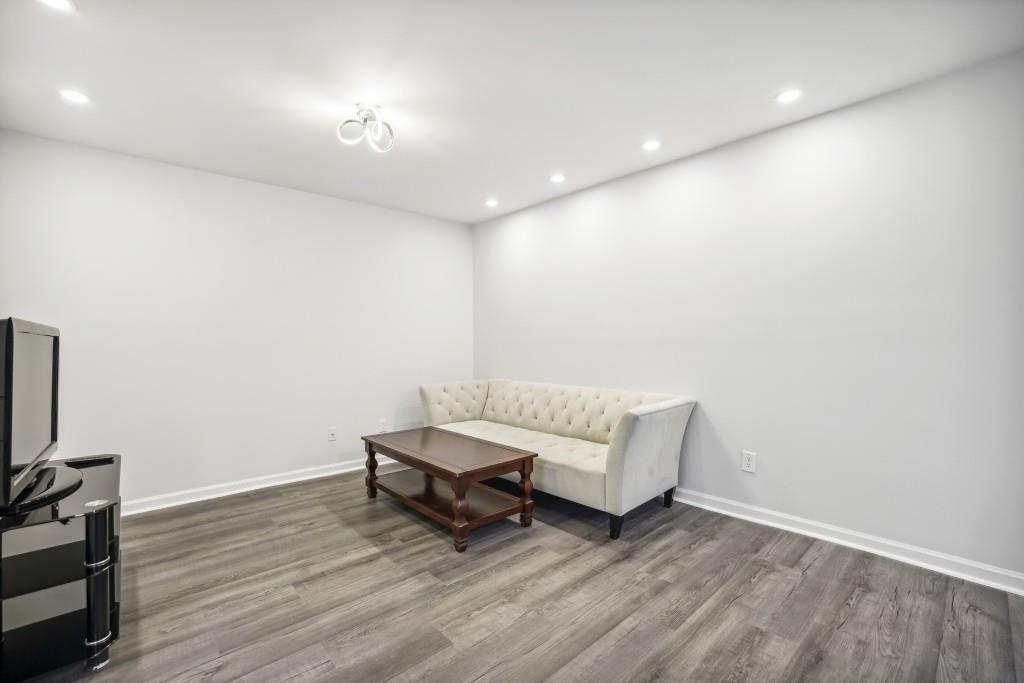 10145 Rillridge Court Alpharetta, GA 30022 - Photo 9 of 26 a living room with furniture and a flat screen tv