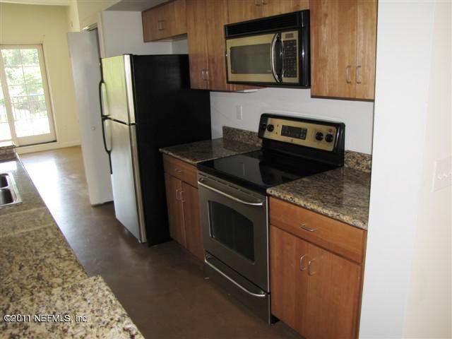1661 Riverside Avenue, Unit 203 Jacksonville, FL 32204 - Photo 3 of 11 a kitchen with a stove microwave and refrigerator