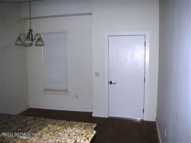 1661 Riverside Avenue, Unit 203 Jacksonville, FL 32204 - Photo 5 of 11 a view of a room with wooden floor and cabinet