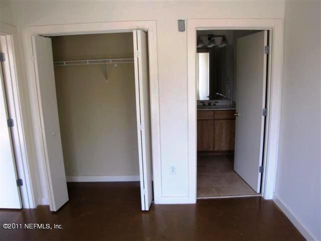 1661 Riverside Avenue, Unit 203 Jacksonville, FL 32204 - Photo 6 of 11 an empty room with wooden floor and closet