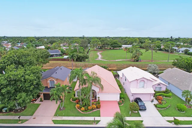 an aerial view of a house with outdoor space and lake view