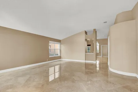 a view of a kitchen with kitchen island granite countertop living room