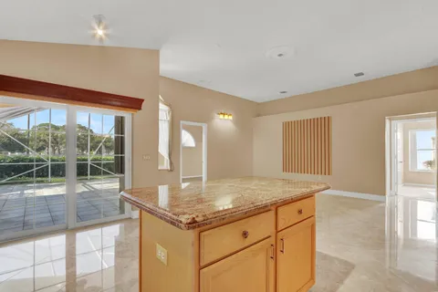 a bathroom with a granite countertop sink a toilet and a mirror