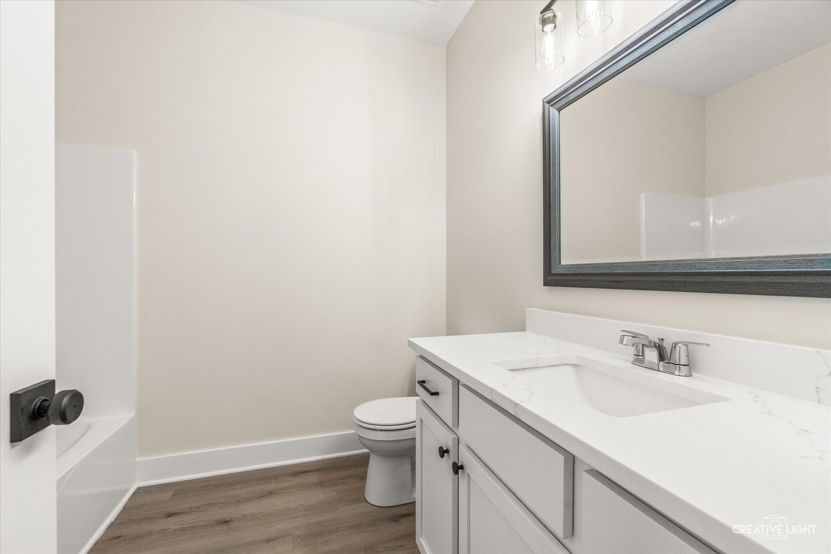 1823 Constitution Street Sycamore, IL 60178 - Photo 11 of 18 a bathroom with a sink toilet and vanity
