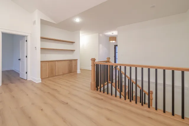 a view of a hallway with closet and racks