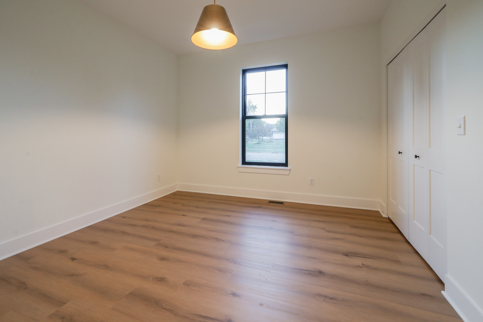 1823 Constitution Street Sycamore, IL 60178 - Photo 22 of 26 an empty room with wooden floor and windows